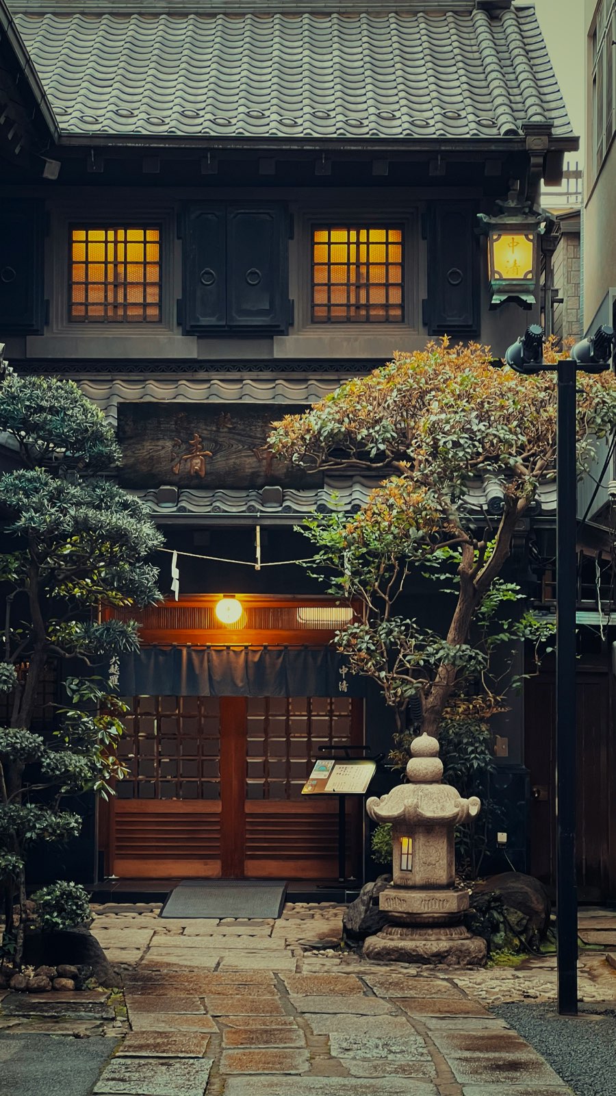 A traditional entrance glowing warm at dusk