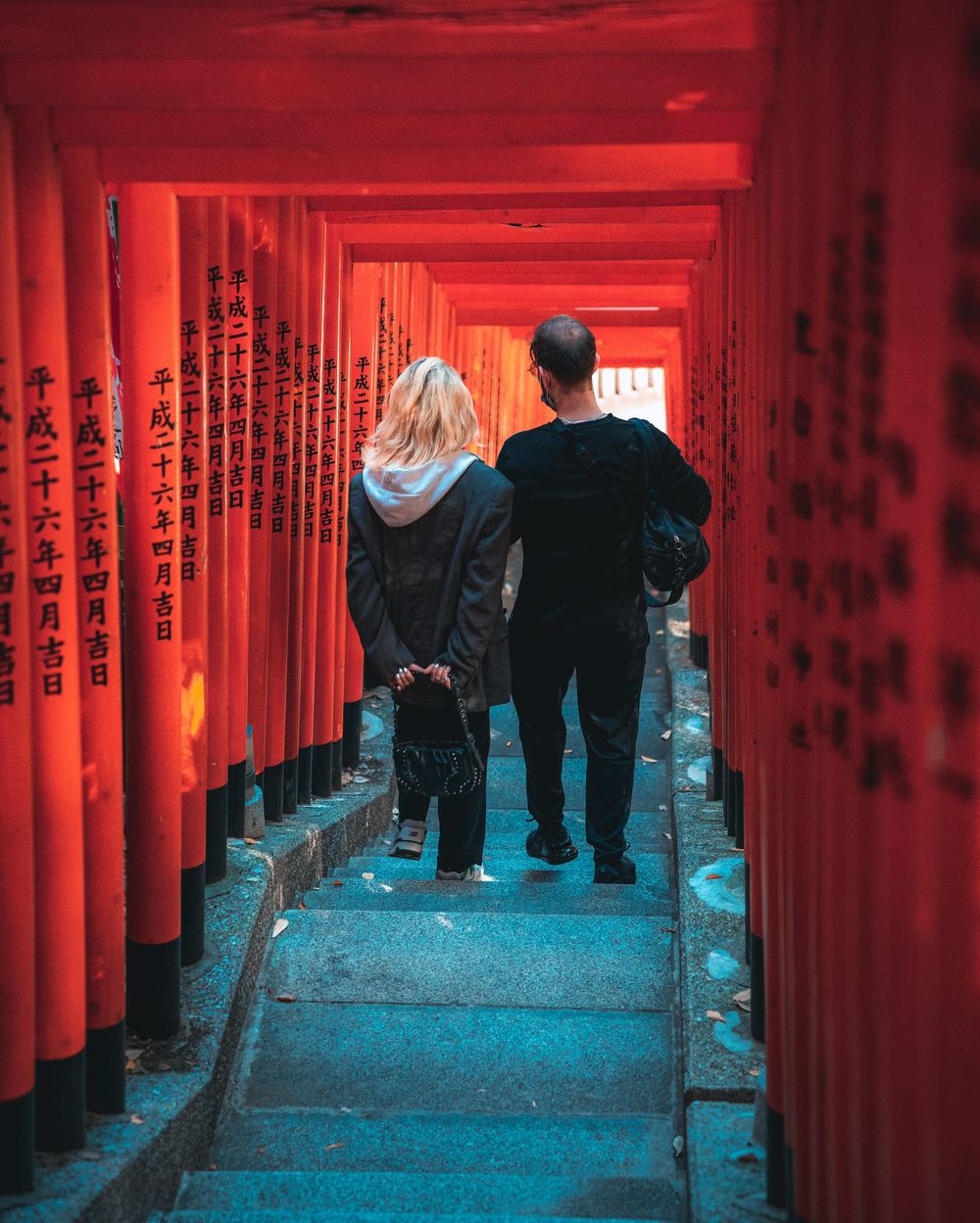 Couple walking together up a gentle stone stairway toward a sacred site